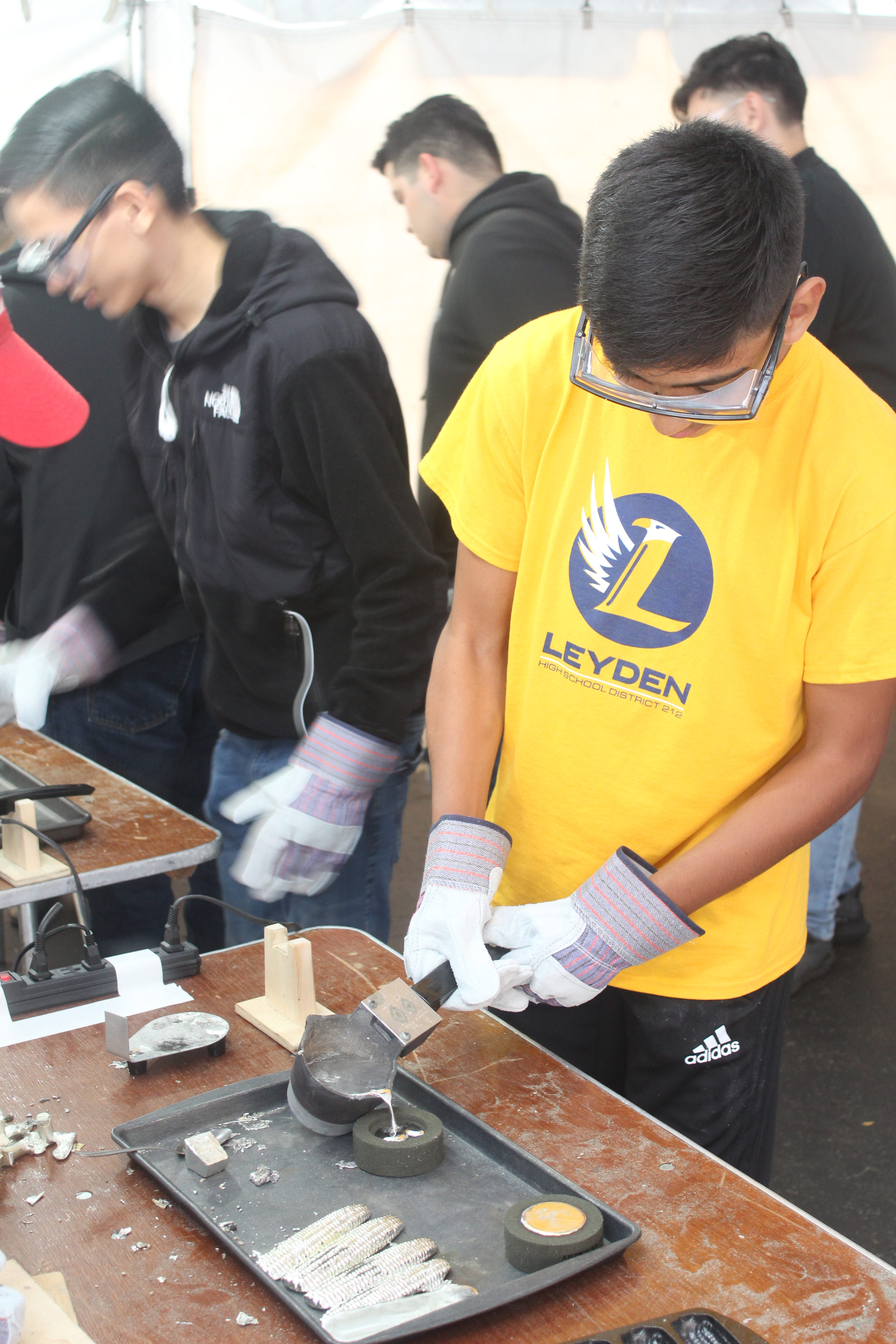 Student pouring tin