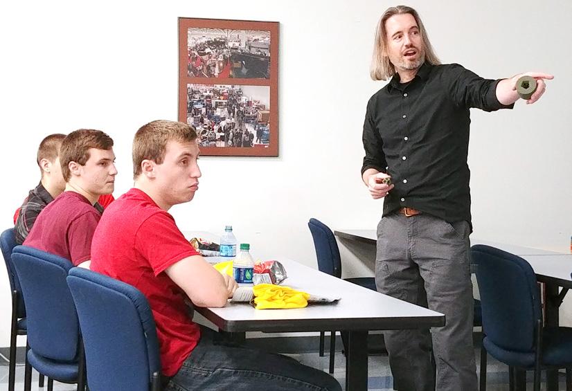 Matthew Cummins, artist in residence at the Museum of Science and Industry, speaks to students during Manufacturing Day.